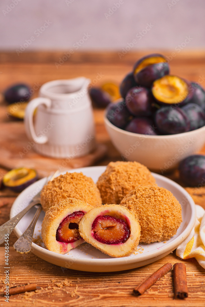 Dumplings with plums in sugar and cinnamon sprinkles Dumplings with plums in sugar and cinnamon sprinkles
