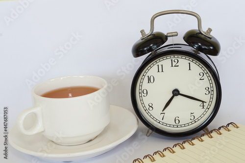 a cup of tea with alarm clock
