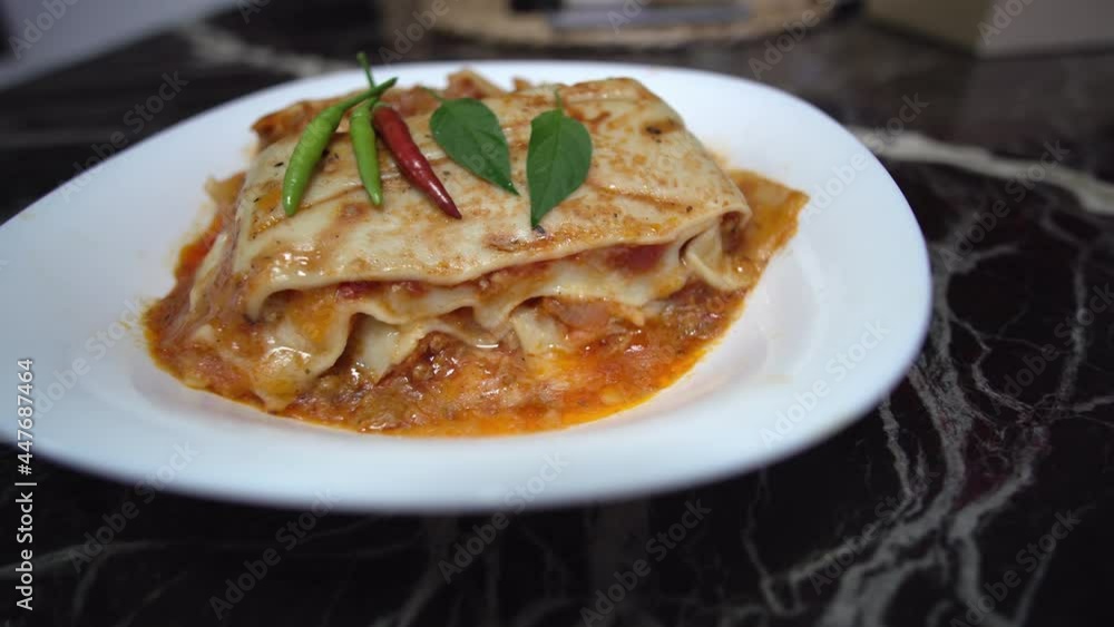 freshly baked lasagna piece on white plate close-up freshly baked lasagna piece on white plate close-up