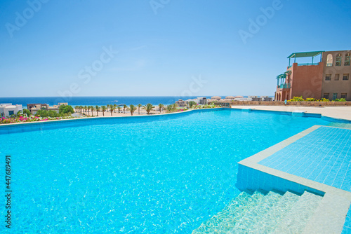 Outdoor swimming pool in a luxury tropical hotel resort © Paul Vinten