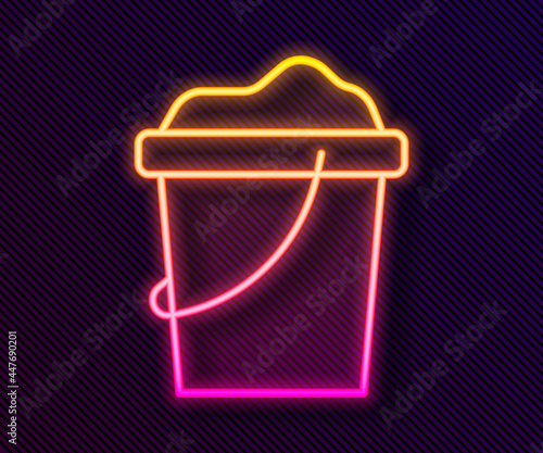 Glowing neon line Sand in bucket icon isolated on black background. Plastic kid toy. Summer icon. Vector