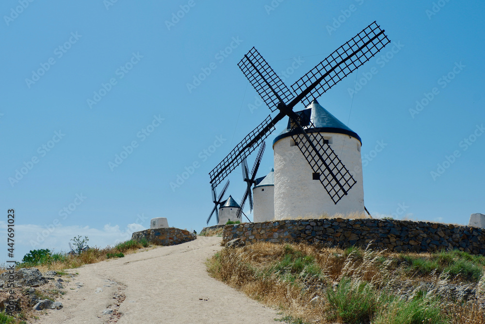 Country road going up to ancient windmills in Consuegra, Castilla La Mancha, Spain
