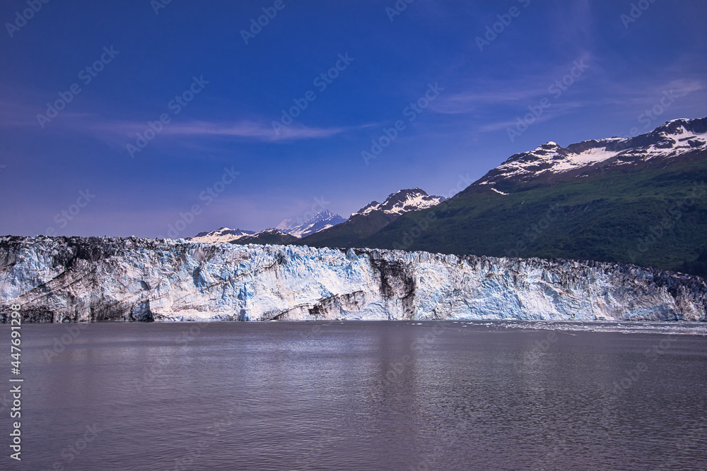 Obraz premium A view of the ice shelf in summer. Little snow on the top of the mountain. Enjoy the view of the ice shelf from the cruise ship. Alaska, USA. July 2019.