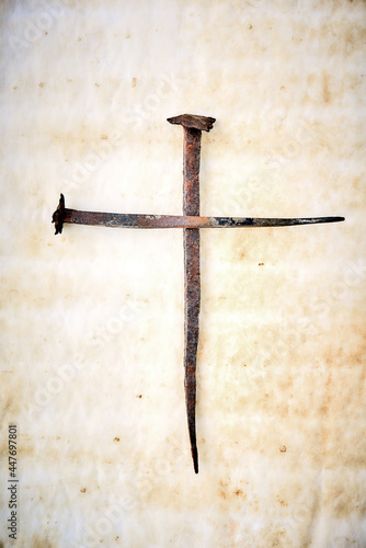 Cross made with rusty nails and drops of blood. Copy space. Good Friday, Easter day. Christian backdrop. Biblical faith, gospel, salvation concept. Crucifixion of Jesus Christ