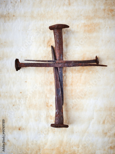 Cross made with rusty nails and drops of blood. Copy space. Good Friday, Easter day. Christian backdrop. Biblical faith, gospel, salvation concept. Crucifixion of Jesus Christ