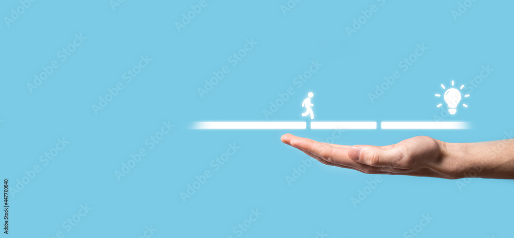 Male business man hand hold a connecting block between two sets of bridge road for a silhouetted man to walk idea icon. Male business man hand hold a connecting block between two sets of bridge road for a silhouetted man to walk idea icon.