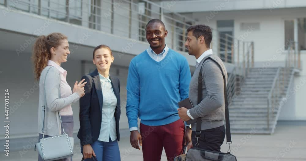 Portrait of happy diverse business team outside office looking at camera Portrait of happy diverse business team outside office looking at camera