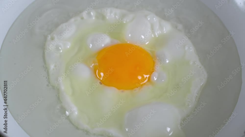 Fresh organic village eggs frying in pan, closeup Fresh organic village eggs frying in pan, closeup
