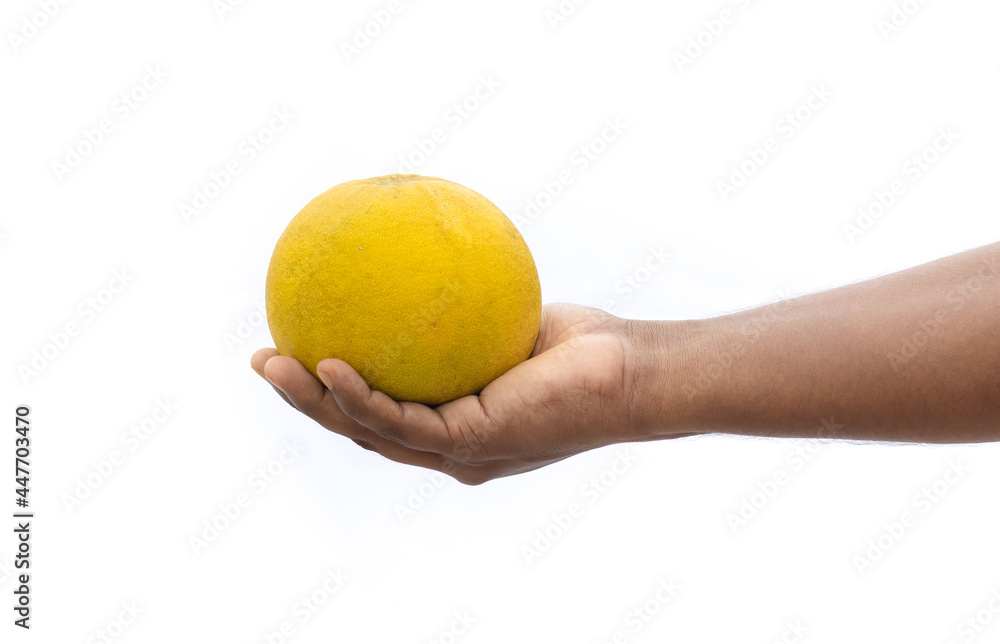 Ripe pomelo fruit on a male hand isolated on white background Ripe pomelo fruit on a male hand isolated on white background
