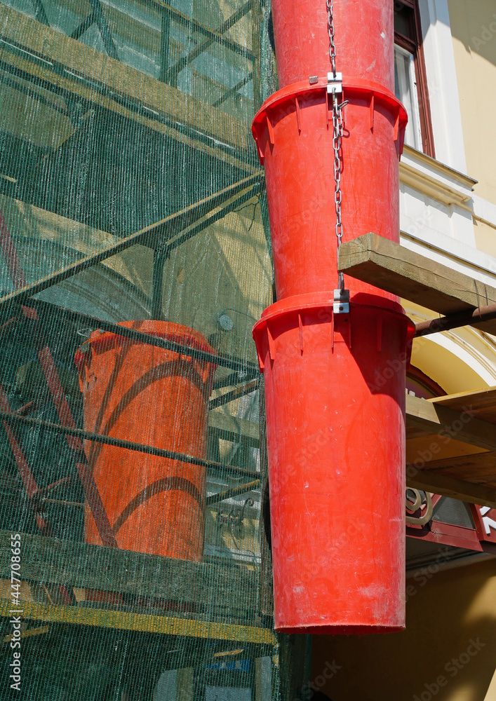 Dumpster plastic pipe at the restoration of a building Dumpster plastic pipe at the restoration of a building