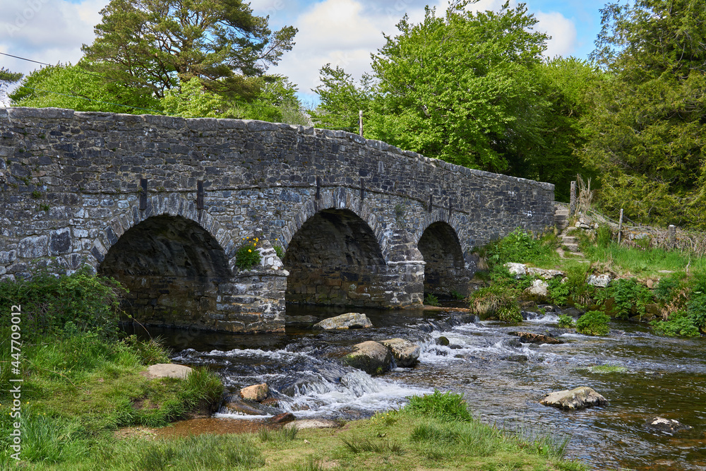 Medieval clapper bridge over the East Dart River at Postbridge on Dartmoor in Devon, West Country, England, UK