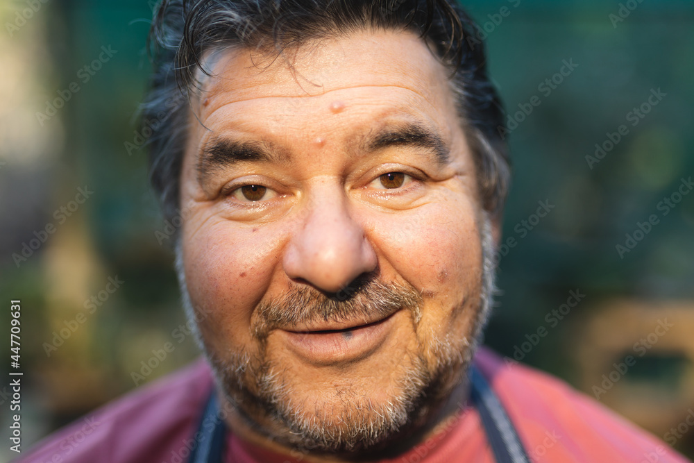 Portrait of happy caucasian male gardener looking at camera at garden centre Portrait of happy caucasian male gardener looking at camera at garden centre