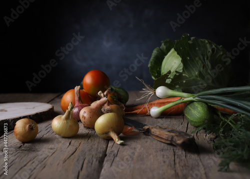 autumn harvest of garden crops on a vintage wooden table