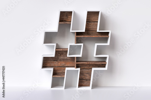 Wood hashtag symbol in the shape of furniture with raw wood shelves. Furniture and interior design social media concepts. 3D rendering. photo