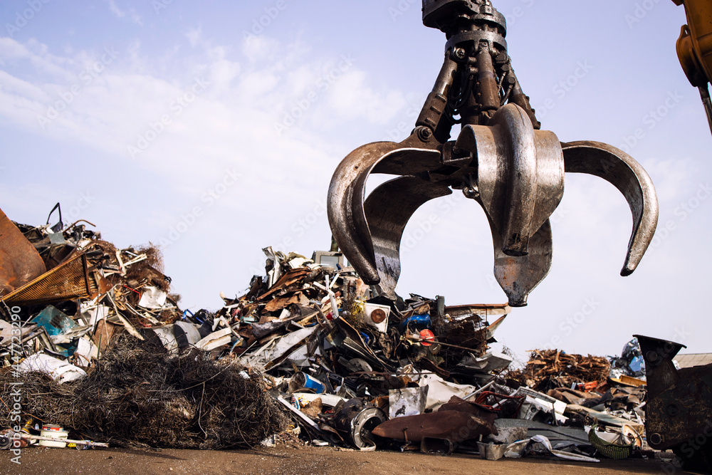 Industrial scrap metal recycling and crane lifting parts in junk yard. - obrazy, fototapety, plakaty 