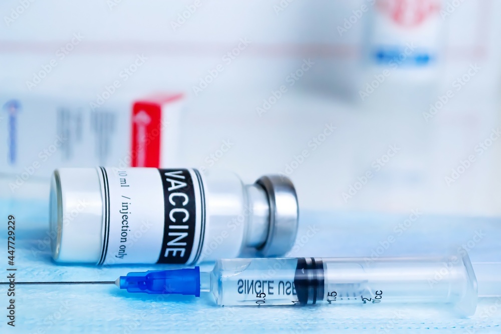 Medical concept. Worldwide vaccination against covid-19. Close-up of a vial with a dose of coronavirus vaccine. Horizontal photo