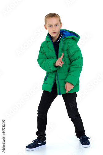 Smiling boy in unbuttoned green winter jacket