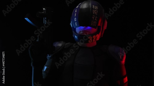 Cyberpunk concept, future world. Police officer cop, halfman bionic cyborg or android holds weapon gun with lantern is in dark. Science fiction scene, fantasy, sci. Portrait. Red blue light. Law Order photo