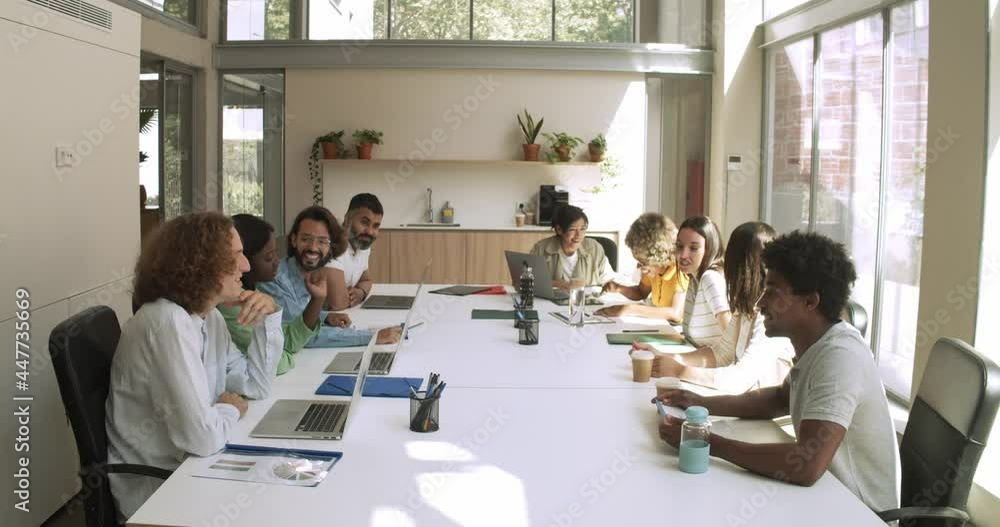 Group of multi-ethnic workers working as a team in an office or coworking space Group of multi-ethnic workers working as a team in an office or coworking space