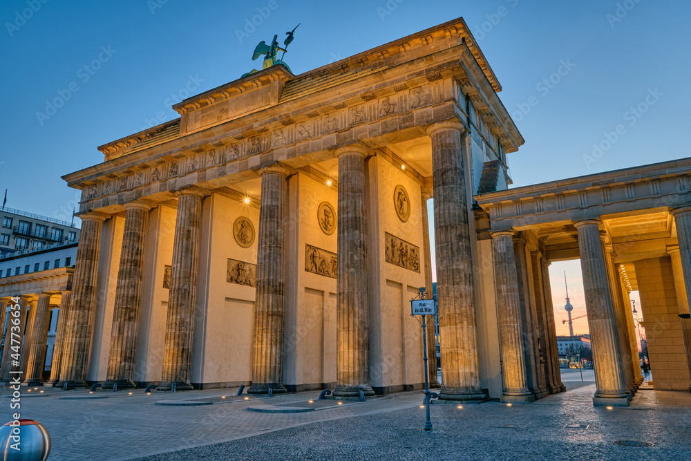 The back side of the famous Brandenburg Gate in Berlin before sunrise with a view to the Television Tower