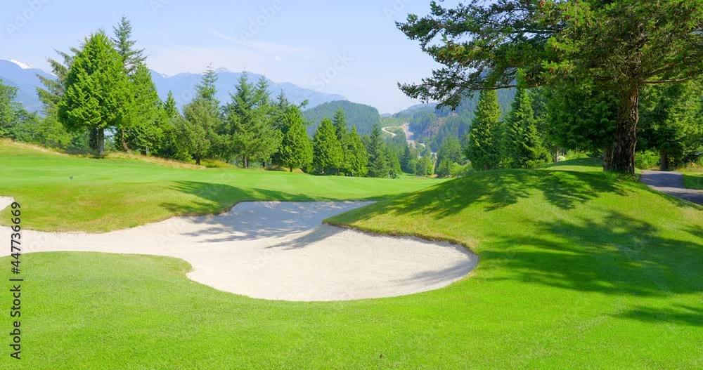 Establishing shot of golf course with gorgeous green and fantastic forest view in Vancouver, Canada, North America. Day time on May 2021. Still camera. ProRes 422 HQ. Establishing shot of golf course with gorgeous green and fantastic forest view in Vancouver, Canada, North America. Day time on May 2021. Still camera. ProRes 422 HQ.