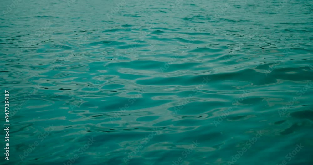 Closeup of clean water flowing in the river. Flow creating glints, and glare on the water surface. Closeup of clean water flowing in the river. Flow creating glints, and glare on the water surface.