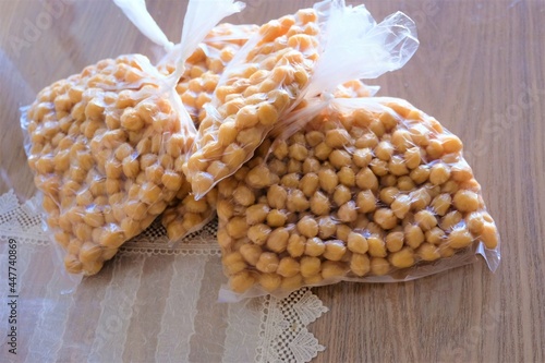 Four plastic bags of chickpeas for the freezer in winter, selective focus. Turkish boiled chickpeas. Putting in a transparent plastic bag for freezing.It is called "Kislik Nohut", "Dondurulmus Nohut" 