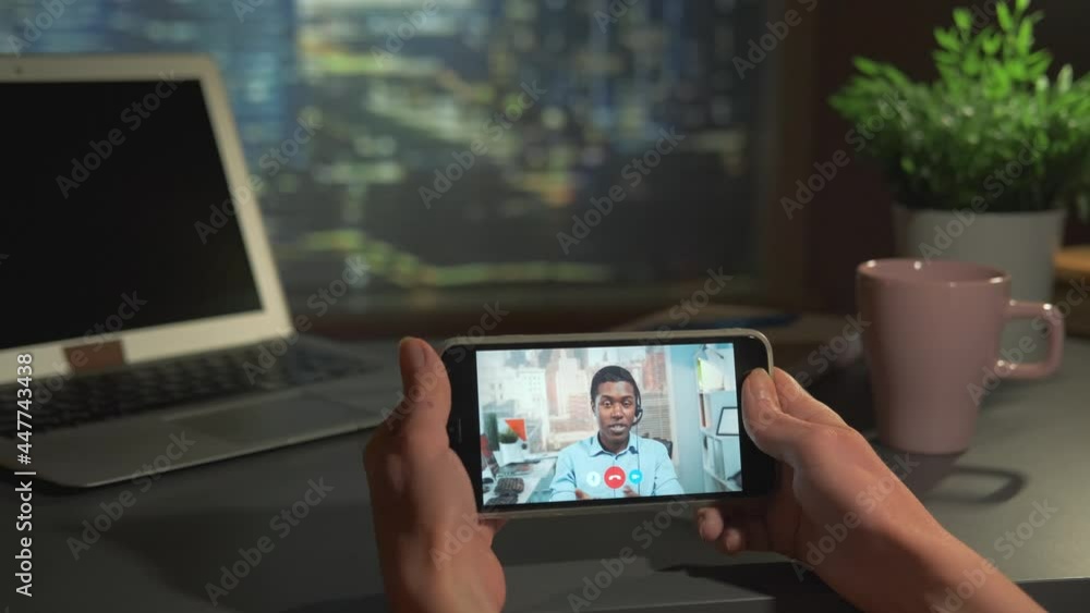 Smartphone with video calling to the manager from office. Female hands holding telephone. Smartphone with video calling to the manager from office. Female hands holding telephone.