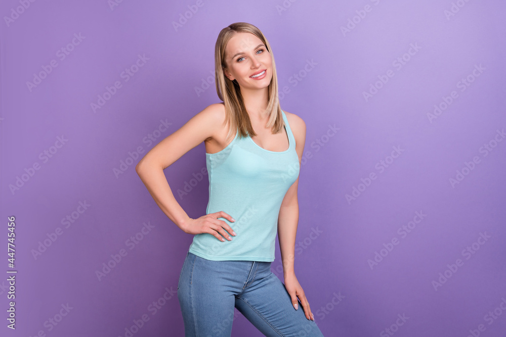 Photo of nice blond millennial lady stand wear blue top jeans isolated on violet color background Photo of nice blond millennial lady stand wear blue top jeans isolated on violet color background