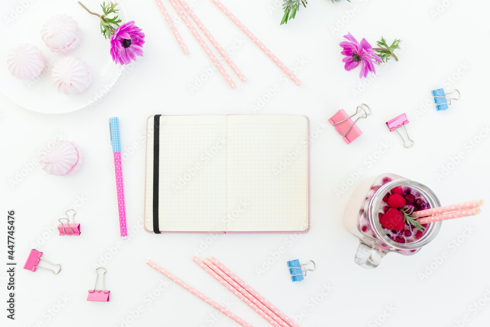 Smoothie with straws, marshmallow, anemones flowers and diary on white background