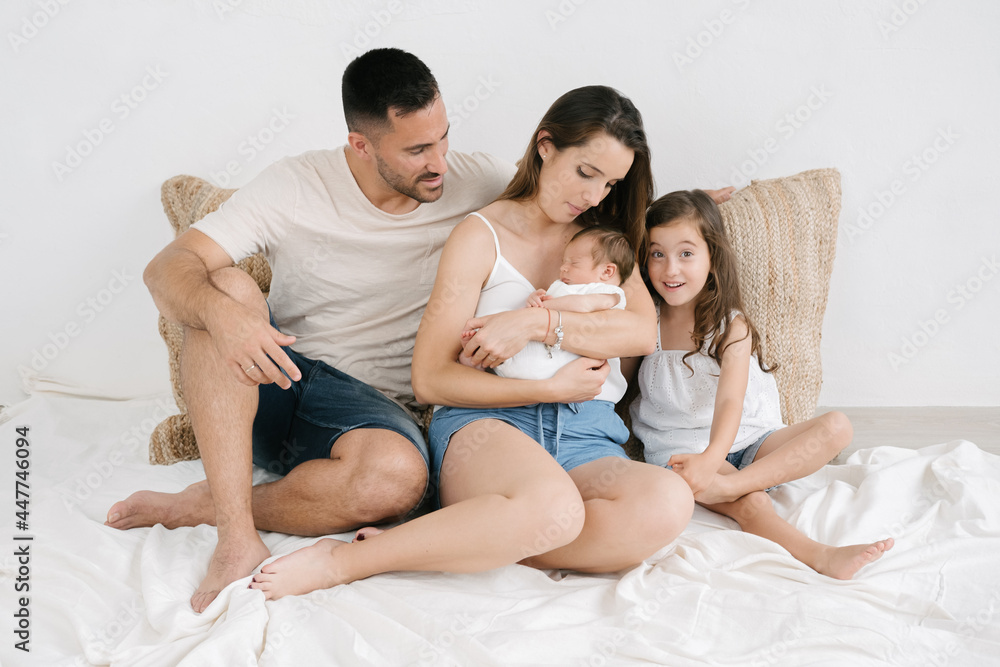Happy family with kids on sofa at home Happy family with kids on sofa at home