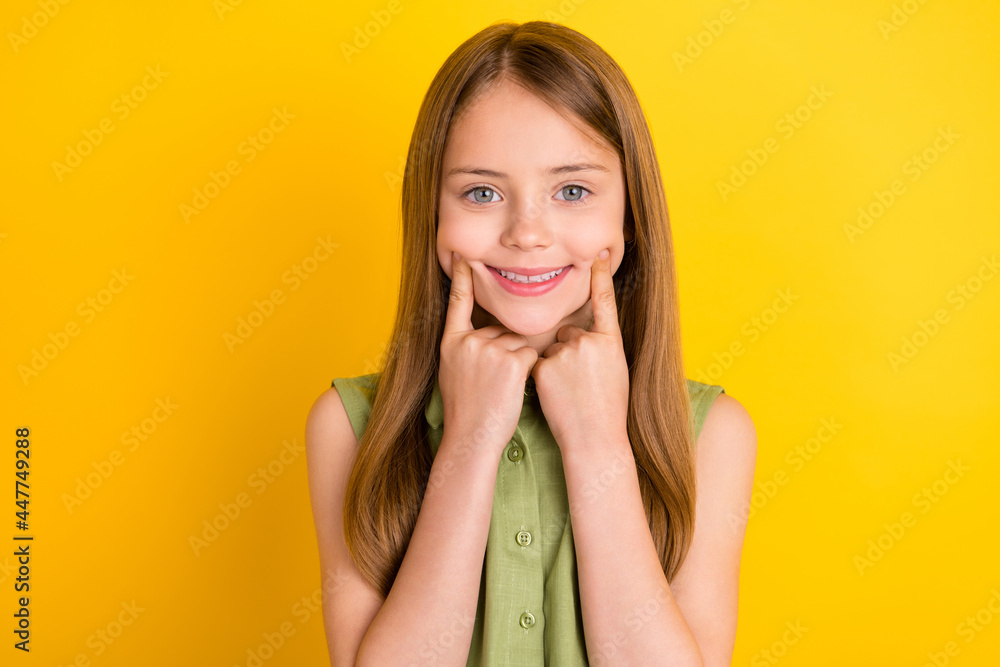 Photo of sweet blond little girl point smile wear khaki blouse isolated on yellow color background Photo of sweet blond little girl point smile wear khaki blouse isolated on yellow color background
