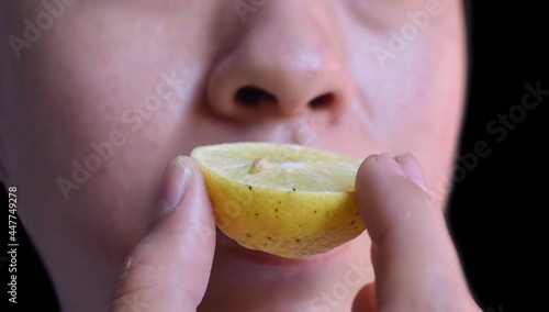 Southeast Asian, Chinese and Myanmar young man with cold flu gets loss of smell called anosmia. He smells scent of lemon while staying at home. photo