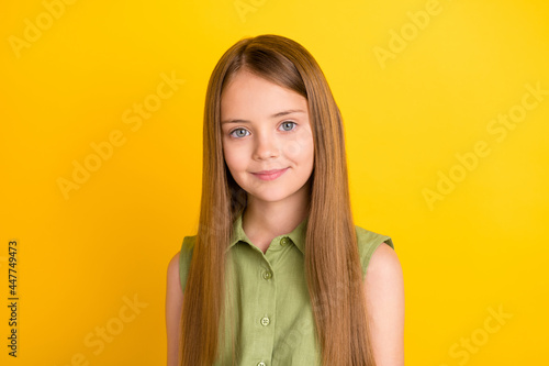 Photo of nice blond small girl wear khaki blouse isolated on yellow color background © deagreez