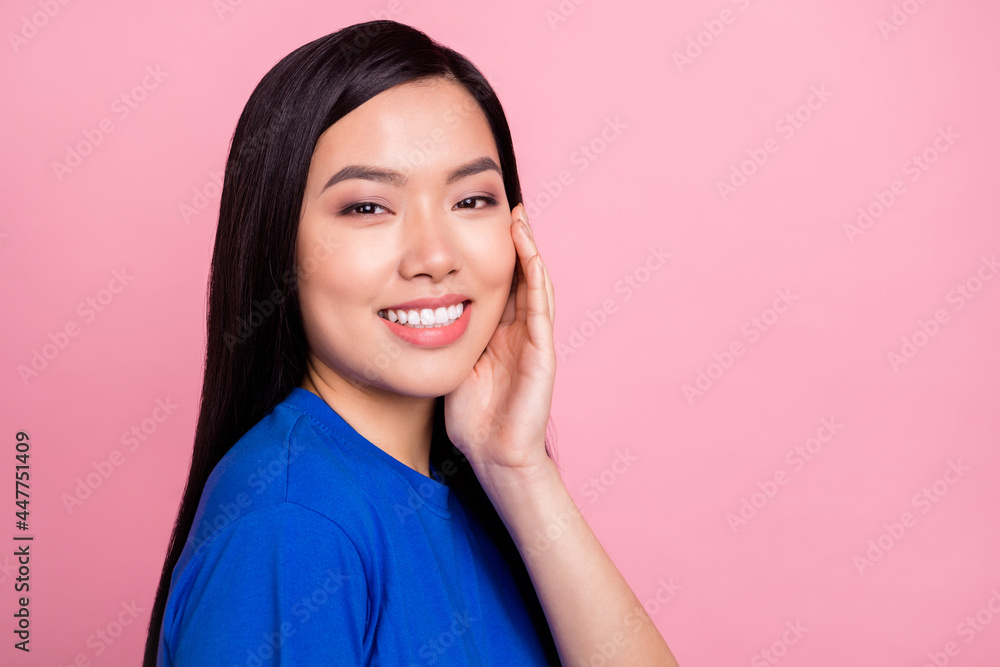 Photo of cheerful young happy woman hold hand face good mood smile isolated on pink color background Photo of cheerful young happy woman hold hand face good mood smile isolated on pink color background