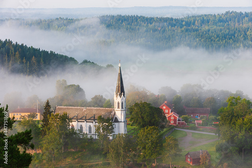 Church lying in misty landscape