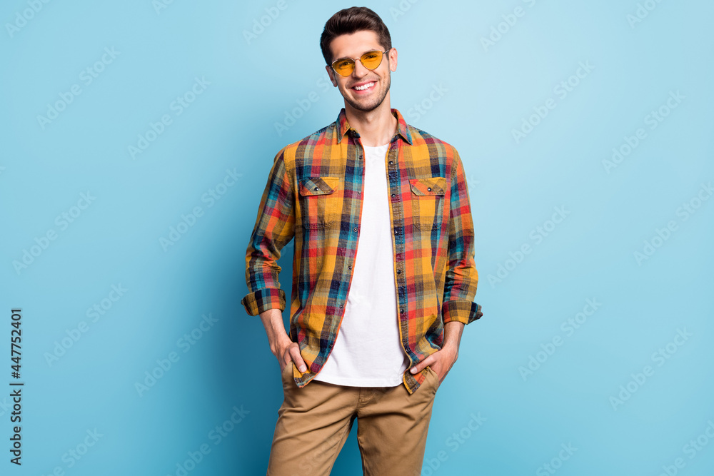Portrait of attractive content cheerful guy wearing cozy clothes specs posing isolated over bright blue color background Portrait of attractive content cheerful guy wearing cozy clothes specs posing isolated over bright blue color background