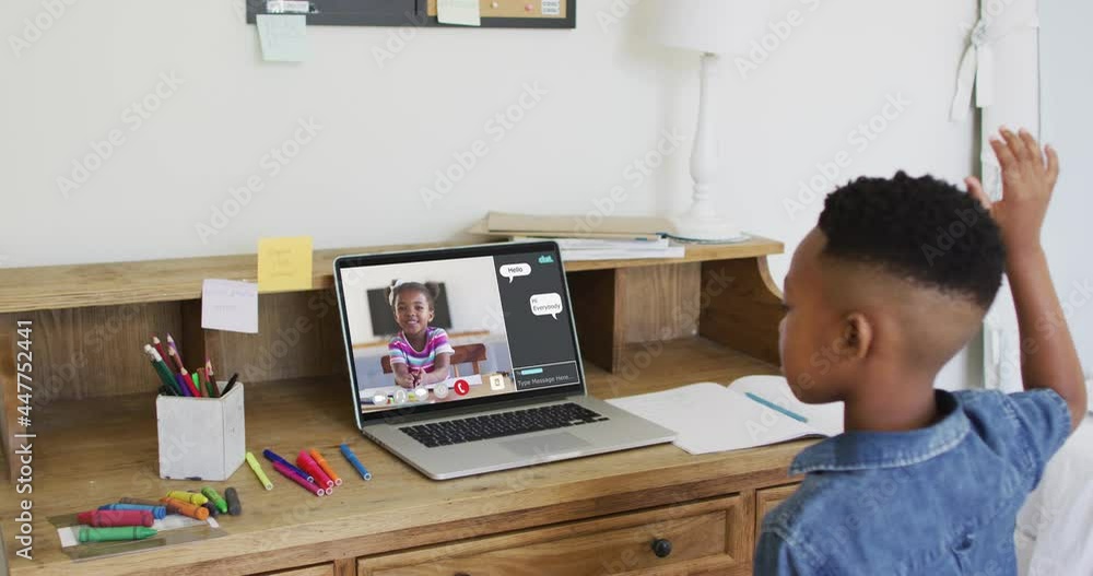 African american boy raising his hands while having a video call on laptop at home African american boy raising his hands while having a video call on laptop at home