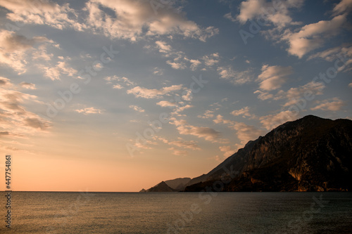 Gorgeous view of the sea  mountains and colorful morning sky with white clouds