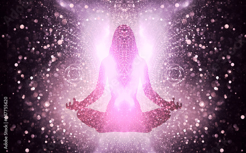 Silhouette of a girl in Lotus position on the background of the universe. A state of trance and deep meditation. A spiritual journey in the universe. photo