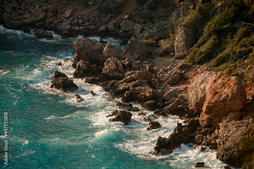 magnificent view of the rocky coast and turquoise sea water with waves