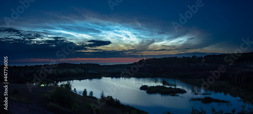 Panorama over an old quarry in the mountain Kinnekulle in Sweden with some beautiful noctilucent clouds.