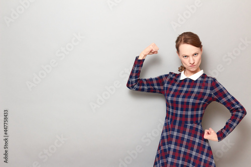 Принти на полотні Portrait of proud rebellious woman posing with fists like bodybuilder