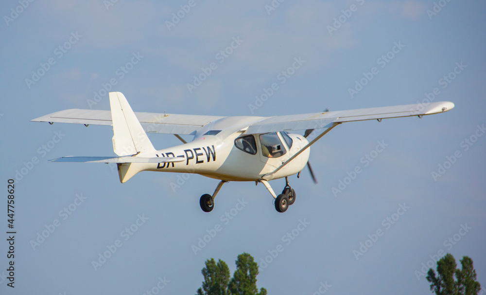 Whiteplane takes off from the airport against the backdrop of a clear sky during the day Whiteplane takes off from the airport against the backdrop of a clear sky during the day