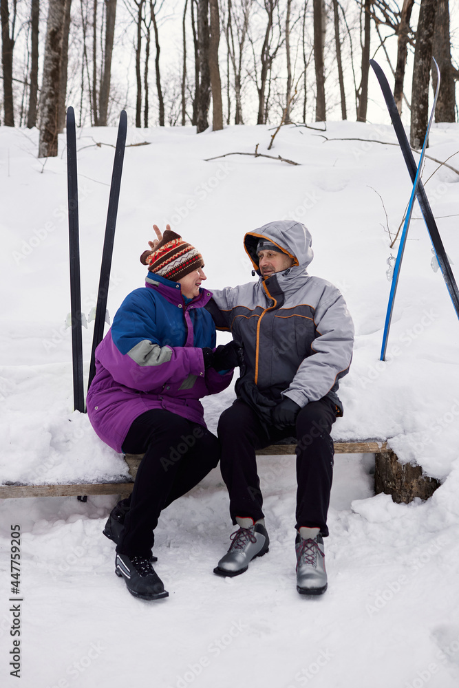 An active elderly couple is engaged in skiing