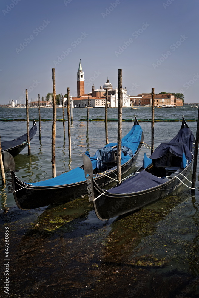 two gondolas in Venice with the Basilica of San Giorgio Maggiore in the background