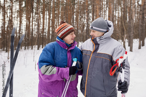 An active elderly couple is engaged in skiing