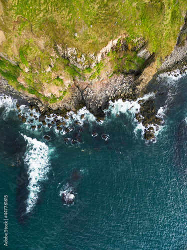 Abstract aerial view of steep cliff along fjord Olafsjfordur, Iceland photo