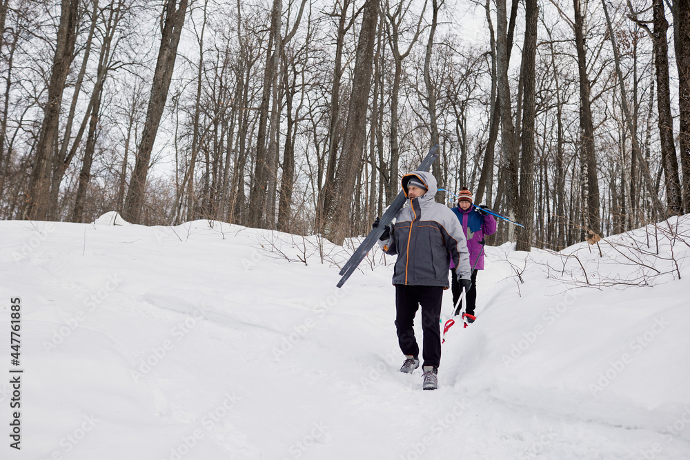 An active elderly couple is engaged in skiing