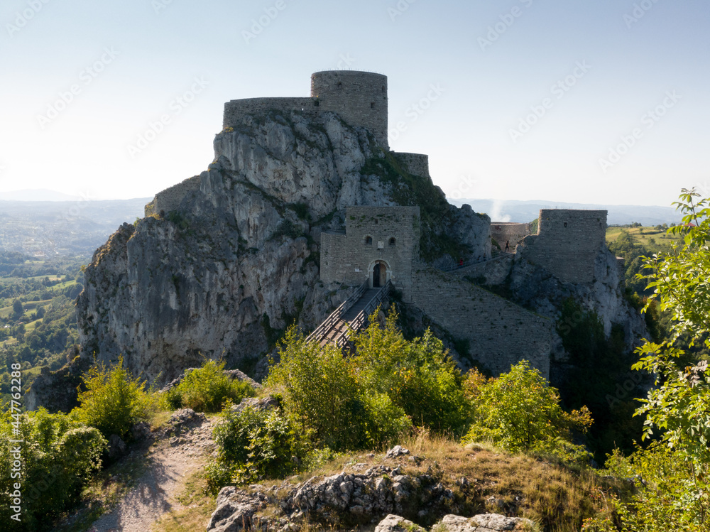 Medieval ottoman fortress near Srebrenik on steep rock with tower-gate, round tower and wooden bridge over the moat